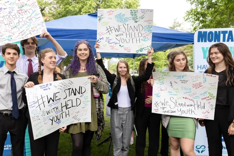 Young people celebrating court victory in cljmate suit