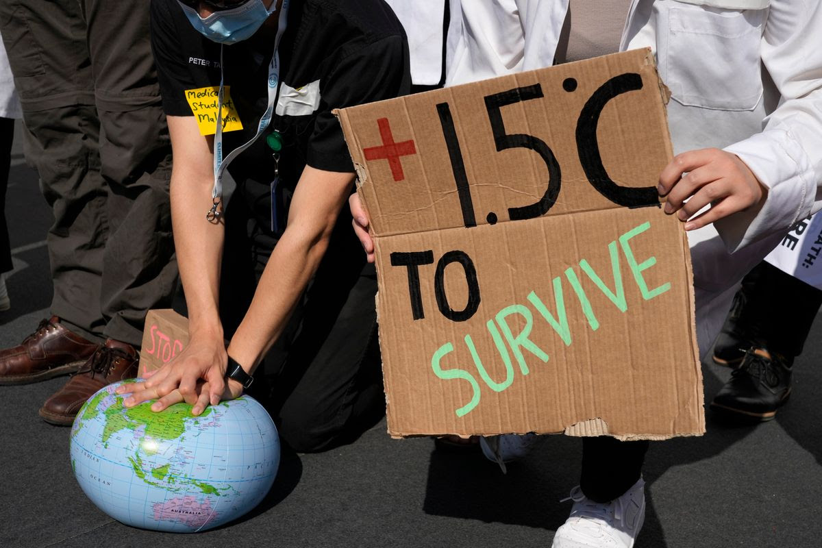 Demonstrators try to “resuscitate” Earth at the U.N. Climate Change Conference in Egypt.